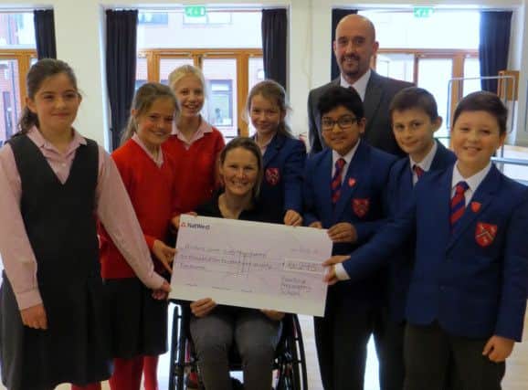 Melton fundraiser extraordinaire Claire Lomas receives the cheque from Fairfield Preparatory School pupils and headmaster Andrew Earnshaw EMN-161202-182705001