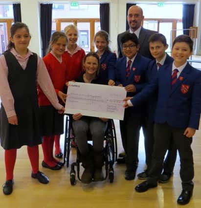 Melton fundraiser extraordinaire Claire Lomas receives the cheque from Fairfield Preparatory School pupils and headmaster Andrew Earnshaw EMN-161202-182705001