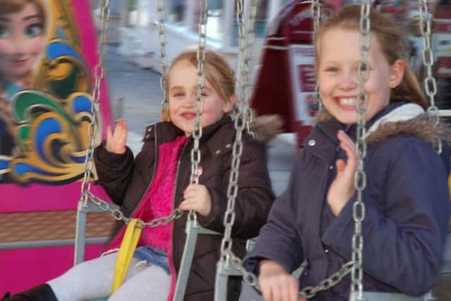 Emily Green (5) and her friend Gracie Spring (9) go for a spin on one of the fair rides PHOTO: Tim Williams