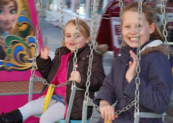 Emily Green (5) and her friend Gracie Spring (9) go for a spin on one of the fair rides  PHOTO: Tim Williams