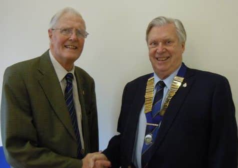 Outgoing president of the Melton mens Pro-bus Club, Brian Mills (left), has handed over the chain of office to his successor Ron Marks (right) PHOTO: Supplied