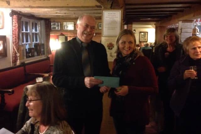 Long-serving village postman Brian Robson receives his cheque from Nicola Wheeler, chairwoman of Hoby with Rotherby Parish Council, at the recent presentation held at the Blue Bell in Hoby EMN-160222-165917001