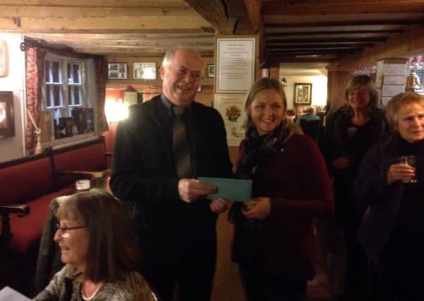 Long-serving village postman Brian Robson receives his cheque from Nicola Wheeler, chairwoman of Hoby with Rotherby Parish Council, at the recent presentation held at the Blue Bell in Hoby EMN-160222-165917001