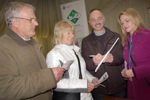 Villagers Malcolm Britton, Jeanne Knowles and Hoby with Rotherby Parish Council clerk Vic Allsop sign up to Rural Watch watched by Leicestershire Police community engagement co-ordinator Emma Smith EMN-160223-175816001