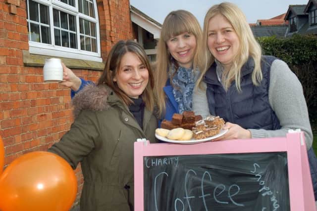 Villagers Alex Beesley, Caroline Pascual and Laura Brudenell White with coffee and cakes at the village hall PHOTO: Tim Williams