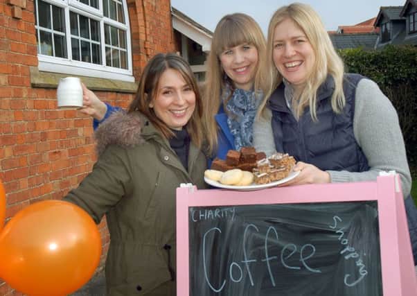Villagers Alex Beesley, Caroline Pascual and Laura Brudenell White with coffee and cakes at the village hall  PHOTO: Tim Williams
