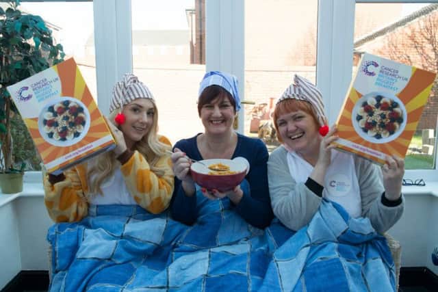 Cancer Research UK's local fundraising manager for Melton, Jayne Sullivan (centre), stages a charity breakfast in bed with colleagues Annie Mitchell (left) and Paula Scaife (right) EMN-160203-110624001