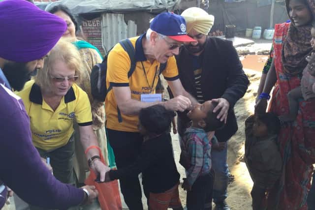Eric applies two vaccine drops to a child under the age of five
PHOTO: Supplied