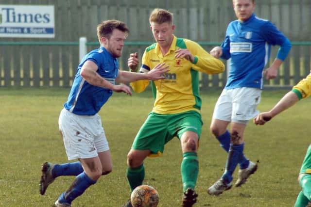 Holwell captain Michael Stevenson gets in a challenge against South Normanton EMN-160315-153018002