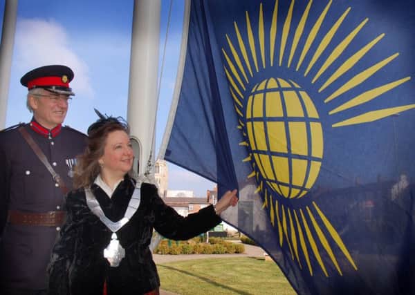 Mayor of Melton Jeanne Douglas raises the Commonwealth Flag assisted by Deputy Lieutenant of Leicestershire David Wyrko QPM DL EMN-160315-094801001