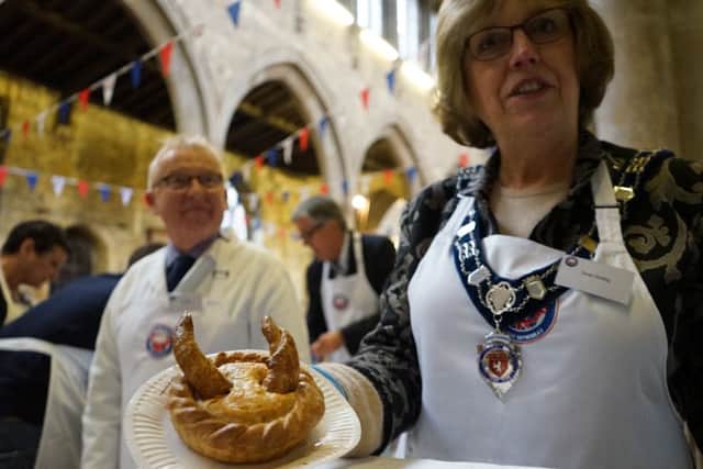 Senior Townwarden and British Pie Awards judge Dinah Hickling inspects one of the more devilish pies EMN-160314-125119001