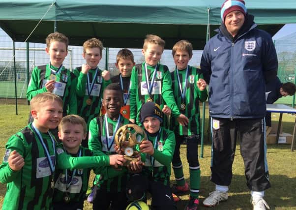 Melton Foxes Jades Under 9s show off the Leicester and District Festival trophy EMN-160315-172529002