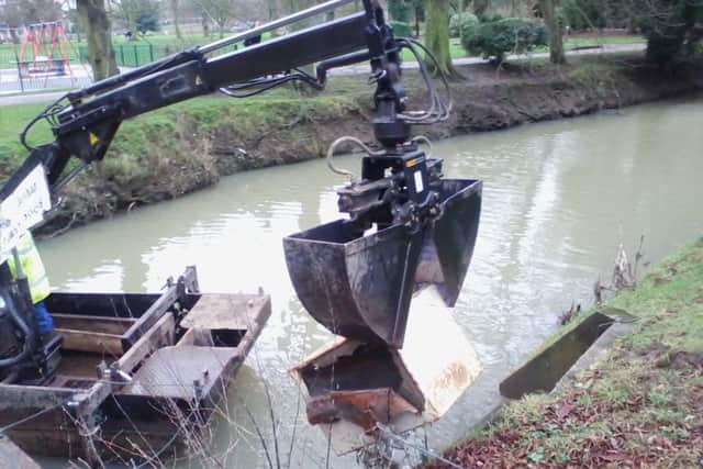 The safe is hauled from the River Eye to the bank side by the society's river clearance boat EMN-160321-173550001