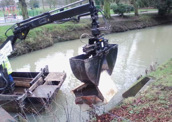 The safe is hauled from the River Eye to the bank side by the society's river clearance boat EMN-160321-173550001