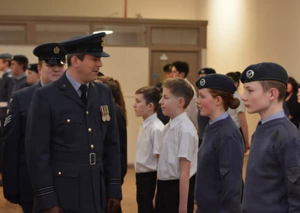 Squadron Leader Mark Richards inspects the cadets 
PHOTO: Supplied