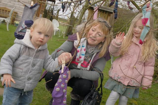 Zak Grant and his sister Amber explore the sock orchard with their grandmother Sammie Grant
PHOTO: Tim Williams