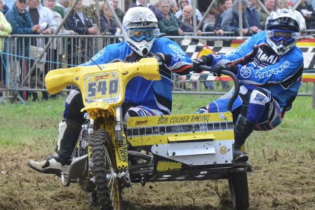 EighteenÂyearÂold Maddison Harvey and stepfather Jamie Nelson muscle their powerful 880cc Yamaha twin over the bumps and jumps of the pre-1984 sidecar class event. EMN-160329-161335002
