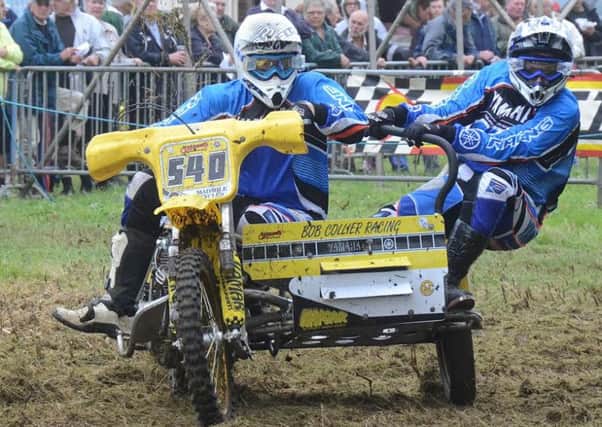 EighteenÂ­yearÂ­old Maddison Harvey and stepfather Jamie Nelson muscle their powerful 880cc Yamaha twin over the bumps and jumps of the pre-1984 sidecar class event. EMN-160329-161335002