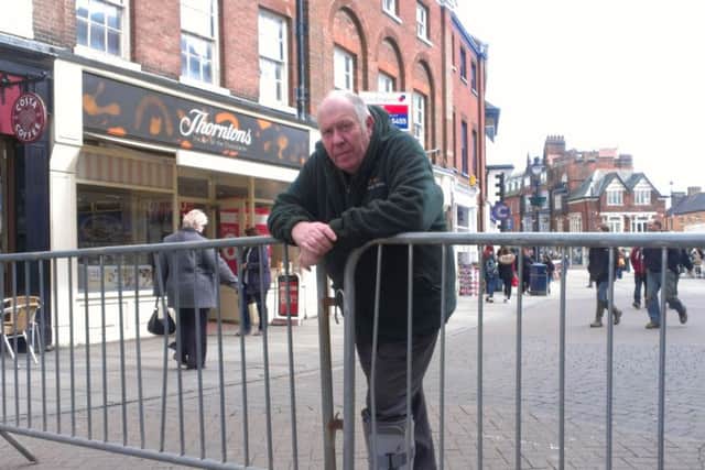 Street market manager Barry Lonsdale and two metal barriers coupled together at the entrance to Cheapside last Wednesday EMN-160404-105258001