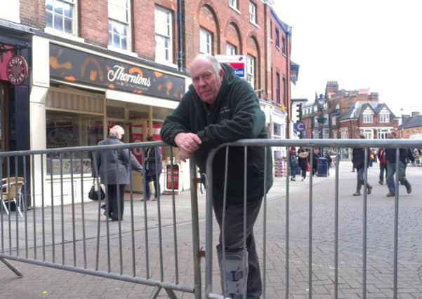 Street market manager Barry Lonsdale and two metal barriers coupled together at the entrance to Cheapside last Wednesday EMN-160404-105258001