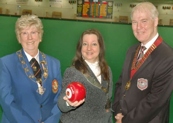 Mayor of Melton Jeanne Douglas prepares to deliver the first bowl with EIBA national president Jenny McConnell and Melton Indoor Bowls Club president David Fry. EMN-161204-112306002