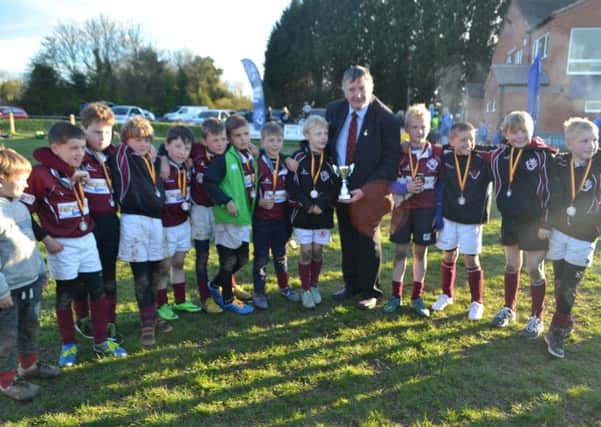 Leicestershire RU representative Brian Hesford presents Melton Under 9s with their trophy EMN-160419-123458002