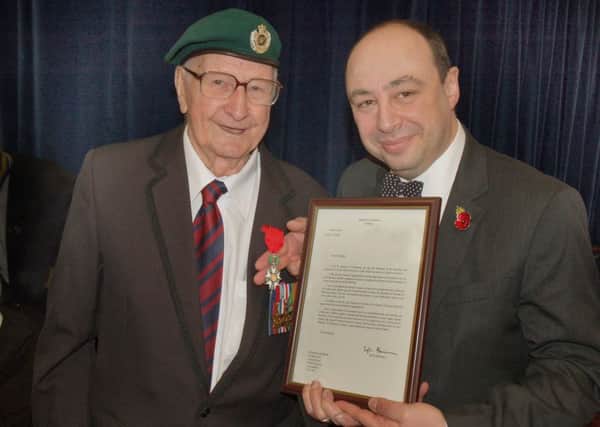 Melton man Maurice Darker is presented with his medal and certificate by Midlands region French consol Jean-Claude Lafontaine EMN-160419-151849001