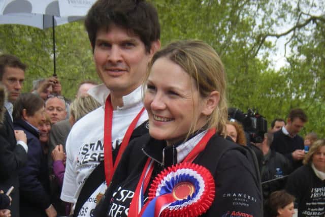 An emotional Claire Lomas and her husband Dan Spincer after crossing the finish line of the 2012 London Marathon EMN-160421-100236001
