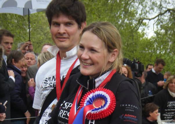 An emotional Claire Lomas and her husband Dan Spincer after crossing the finish line of the 2012 London Marathon EMN-160421-100236001