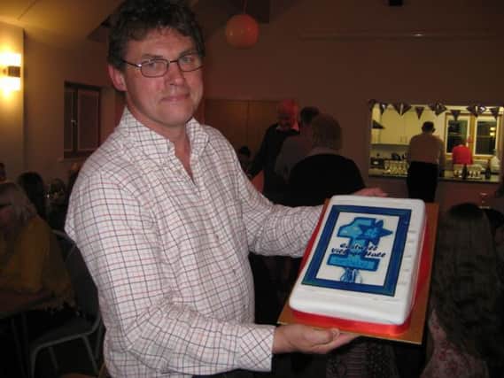 Eastwell Village Hall chariman Phil Norgate with the anniversary cake PHOTO: Supplied
