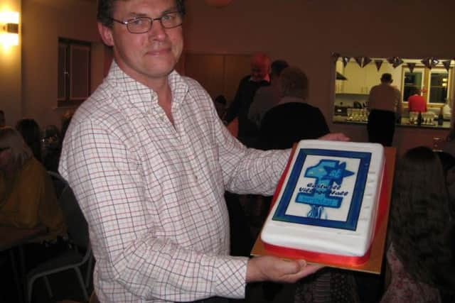Eastwell Village Hall chariman Phil Norgate with the anniversary cake PHOTO: Supplied