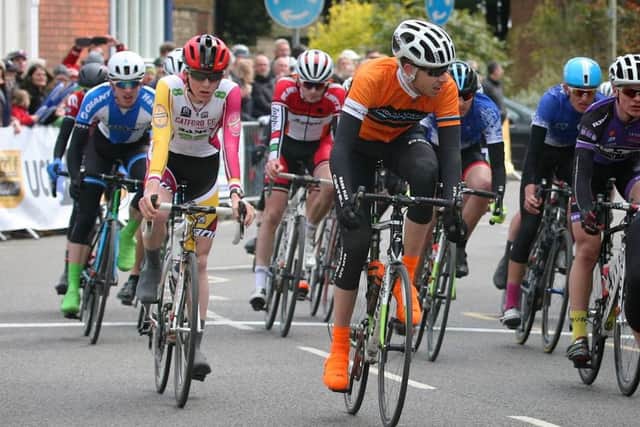 George Sewell (orange top) came home safely in the peloton EMN-160305-115642002