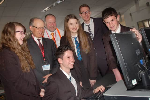 The Melton Building Society chief executive Martin Reason with Year 10 Long Field Academy pupils, assistant principal Craig Palmer and Ed Flack from WizeUp EMN-160428-160400001