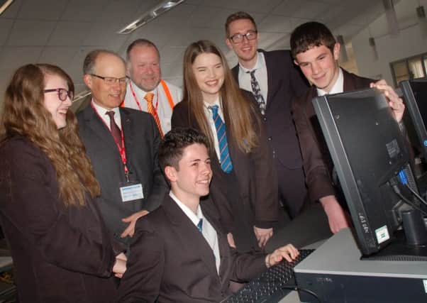 The Melton Building Society chief executive Martin Reason with Year 10 Long Field Academy pupils, assistant principal Craig Palmer and Ed Flack from WizeUp EMN-160428-160400001