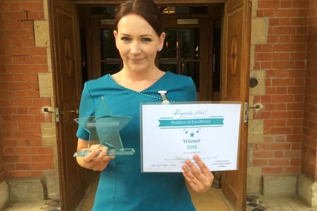 Holly with her winner's certificate and trophy EMN-160428-170706001