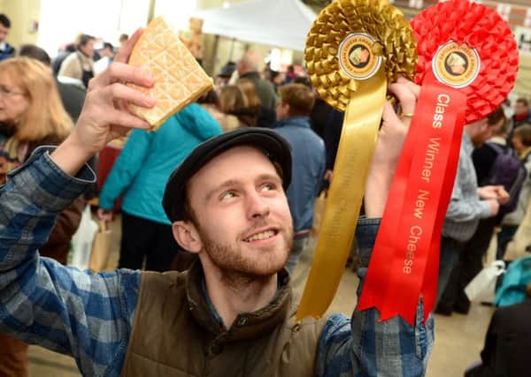Supreme Champion David Jowett of King Stone Dairy with his rosettes and champion Rollright washed rind cow's milk cheese. EMN-160305-174727001