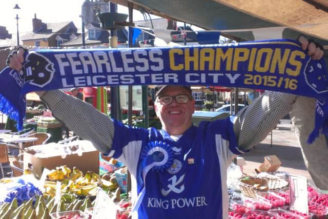 Melton Market stallholder and Leicester City fan Lennie Greet celebrates the Foxes winning the Premier League EMN-160305-094841001