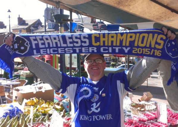 Melton Market stallholder and Leicester City fan Lennie Greet celebrates the Foxes winning the Premier League EMN-160305-094841001