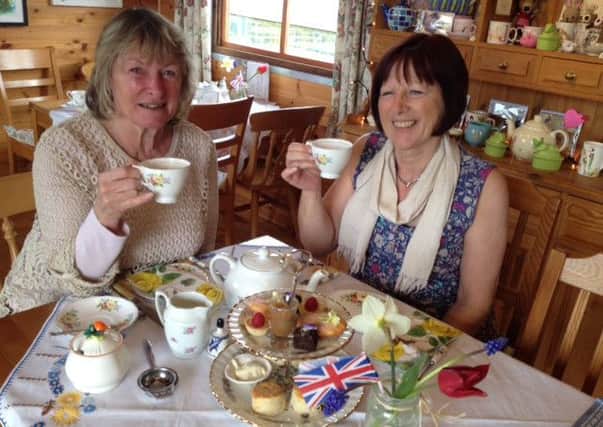 Maureen Ake with her sister enjoying the delights of a decadent royal afternoon tea 
PHOTO: Supplied