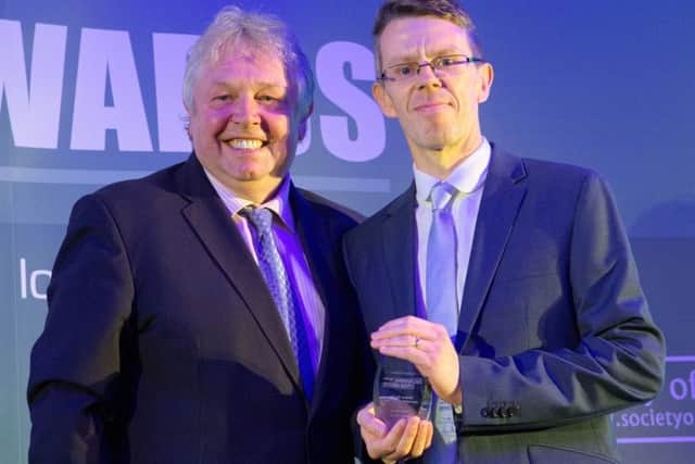 Melton Times sports editor Chris Harby receives the Weekly Sports Journalist of the Year award from radio broadcaster Nick Ferrari at the UK Regional Press Awards EMN-160605-132208002