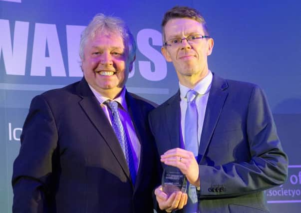 Melton Times sports editor Chris Harby receives the Weekly Sports Journalist of the Year award from radio broadcaster Nick Ferrari at the UK Regional Press Awards EMN-160605-132208002
