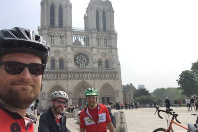 Dan Norcott (left) with friends Rich Moss (right) and Andy Stafford at Notre Dame Cathedral
PHOTO: Supplied