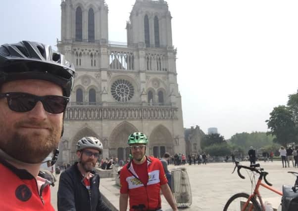 Dan Norcott (left) with friends Rich Moss (right) and Andy Stafford at Notre Dame Cathedral 
PHOTO: Supplied