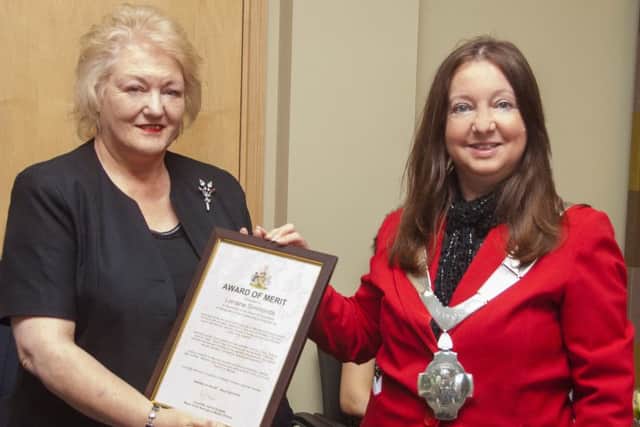 Lorraine Simmonds is presented with her award from Mayor Jeanne Douglas
PHOTO: Whitehouse Photography