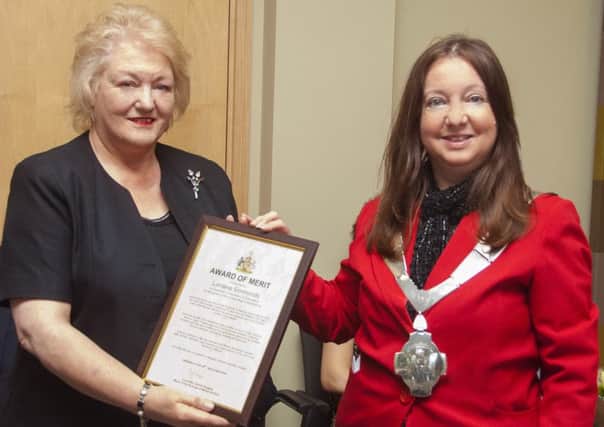 Lorraine Simmonds is presented with her award from Mayor Jeanne Douglas
PHOTO: Whitehouse Photography