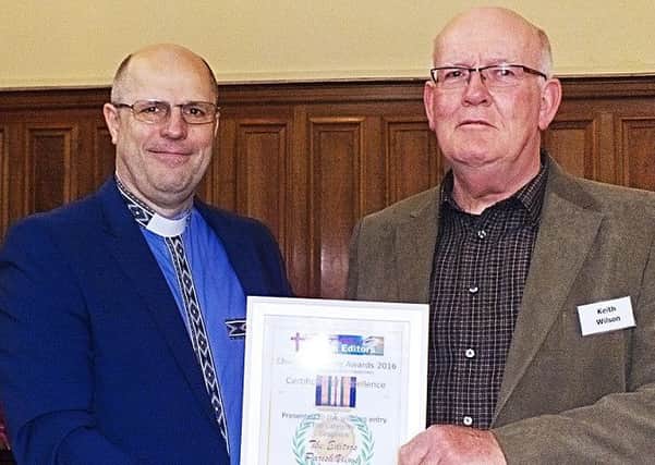Keith Wilson (right) is presented with his award from Reverend Tony Miles 
PHOTO: Supplied