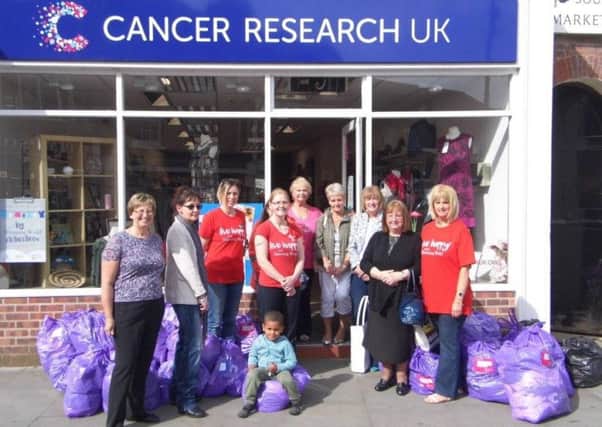 Melton Slimming World consultants and members with Cancer Research UK shop manager Eva Pone and a shop volunteer. EMN-160521-095432001