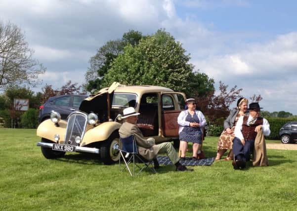 A 1938 Citroen Traction Avant with a suitably attired picnic party enjoying a sunny afternoon picnic on the lawns in front of the Old Brickyard Tea Garden in Scalford 
PHOTO: Supplied