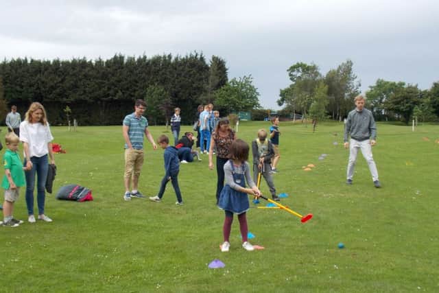 Assistant professional Callum Relf guides yougnsters through Tri Golf training at Melton GCs Funday Sunday EMN-160614-153026002
