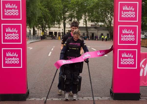 Eye Kettleby mum-of-one Claire Lomas crosses the finish line of the Vitality London 10,000 EMN-160615-125134002